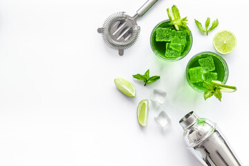 Green Mojito cocktail with bar utensils and ingredients. Top view