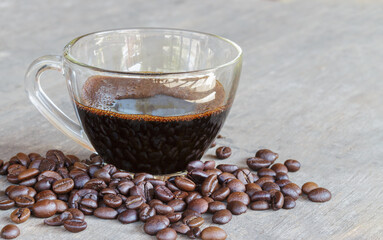 Black coffee in a cup and coffee beans