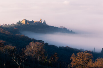 Little town in Umbria (Italy) over a sea of fog at dawn