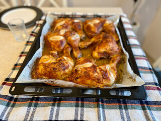 Baked Chicken Legs in Oven Tray with Baking Paper Sheet.