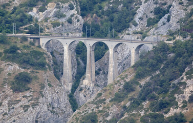Fototapeta na wymiar Old stone viaduct in the Swiss mountains