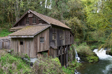 An eye level view of Cedar Creek grist mill from the bridge looking towards the mill and river