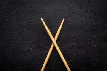 Fototapeta na wymiar Two wooden drum sticks, top view. Music background