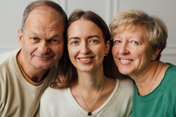 Close up portrait of family with elderly mature woman, man and millennial daughter