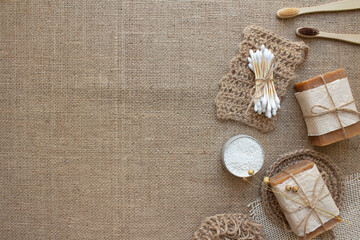 Set of natural bathroom and home spa tools, sustainable zero waste and lifestyle concept. Wooden toothbrushes, bamboo swabs, soap, dry shampoo, toothpowder on fabric background with copy space. Mockup
