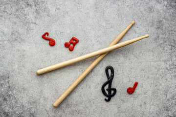 Drum sticks with music notes, overhead view. Music background