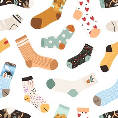Seamless texture with cute cotton and woolen socks with different drawings, patterns and designs isolated on white background. Endless backdrop with warm garments. Colored flat vector illustration