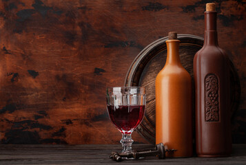 Wine bottles and old wooden barrel