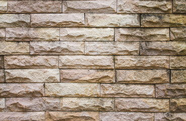 close up old brick wall texture background , brickwork or stonework grid uneven bricks design stack.
