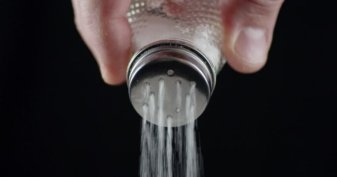 Salt is slowly pouring out of the salt. 