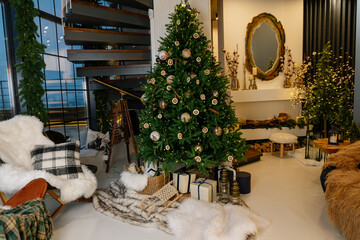 Feast of Christmas. Beautifully decorated house with a Christmas tree ipodarkami underneath