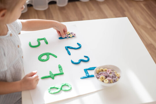 Child Practice Motor Skills, Make A Numbers With Play Dough. Home Education.