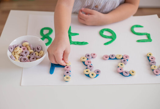 Child Practice Motor Skills, Make A Numbers With Play Dough. Home Education.