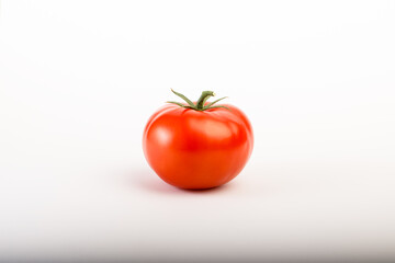 Red round tomato on white background