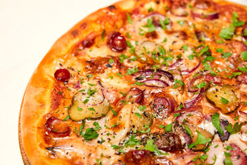 Fresh pizza pickles, bacon, sausages and cheese on a wooden board. Close-up, selective focus