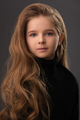 portrait of a beautiful child girl with long beautiful hair in a hairstyle