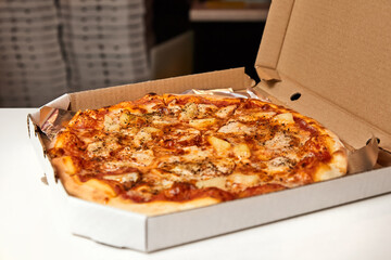 Pizza in an open box prepared for delivery
