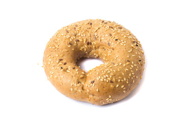 Traditional whole wheat bagel with linseeds and sesame seeds isolated on white