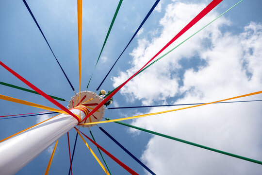 Traditional English Maypole with coloured ribbons.
