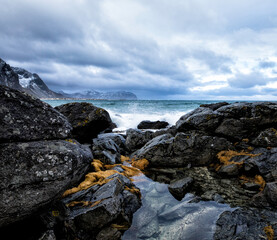 Fototapeta na wymiar Beautiful landscape. Sea stones against a white cloud