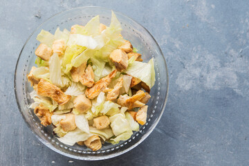 Caesar salad with toast, lettuce and grilled chicken breast