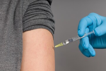 Close up of doctor's hand applying coronavirus vaccine