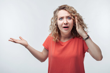 Image of young shocked woman expressing surprise on camera. Human emotions, facial expression concept
