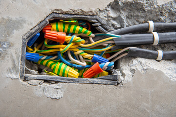 Using an insulating connection clamp or a twist in connecting wire nut to connect electrical wires...