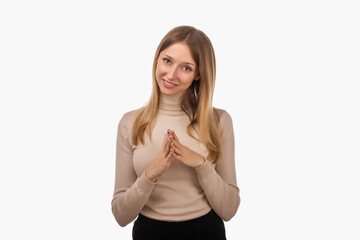Pleasant young blond woman hold hands on heart thanking for compliments or praises. Studio shot,...