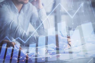 Multi exposure of man and woman working together and financial chart hologram. Business concept. Computer background.