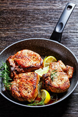 fried pork chops on a skillet, top view