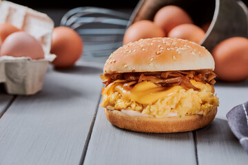 Burger with browned bun, caramelized onion, melted cheese and eggslut