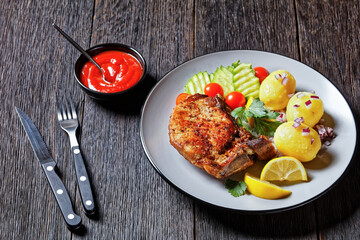 pork cutlets with boiled potato and cucumber