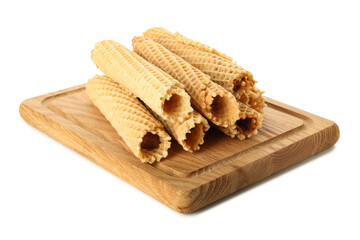 Board with wafer rolls with condensed milk isolated on white background