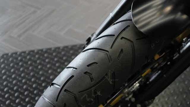 The rubber tread of a new sports bike in the dealer showroom.