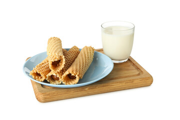 Board with wafer rolls with condensed milk and milk isolated on white background