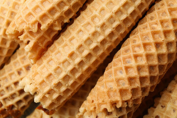 Tasty wafer rolls with condensed milk, close up