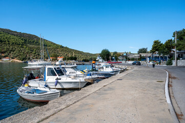 Fototapeta na wymiar Moored boats near a village in Greece