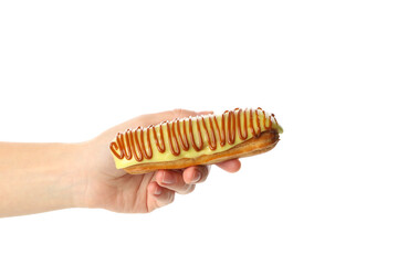 Female hand hold tasty eclair, isolated on white background