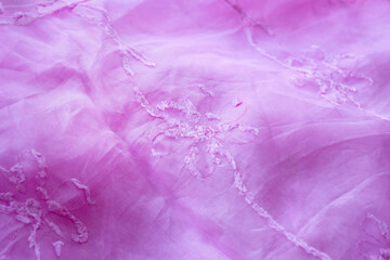 Pink background from silk organza with floral embroidery.