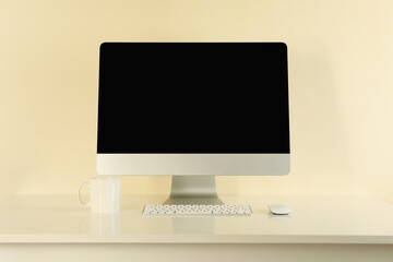 Minimalist workspace concept with desktop computer on beige background