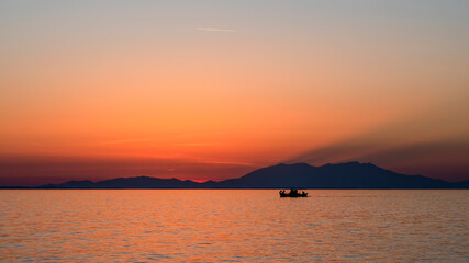 Fototapeta na wymiar Sunset on the Aegean sea coast in Greece