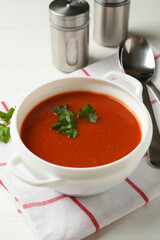 Concept of tasty dinner with tomato soup on wooden background