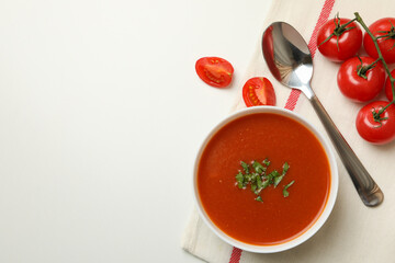 Concept of tasty food with tomato soup on white background