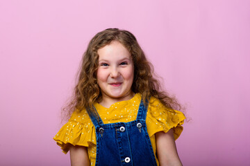 Happy child emotions. Energetic, angry, surprised joyful adorable little girl on studio background.