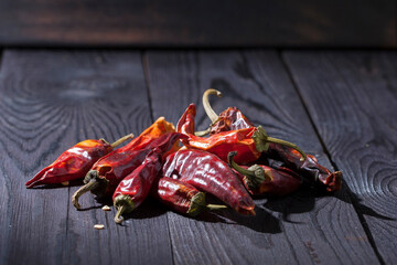 chili pepper hot red and dried on a dark wooden surface