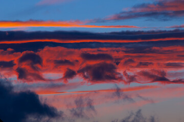 sky landscape with unusual clouds of rich colors at sunset