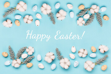 Craft Easter eggs on blue pastel background, space for text. Flat lay image composition, top view.