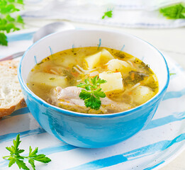 Chicken soup with noodles and vegetables in bowl.