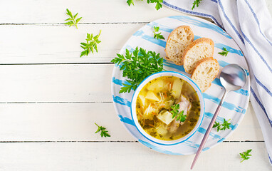 Chicken soup with noodles and vegetables in bowl. Top view, overhead, copy space